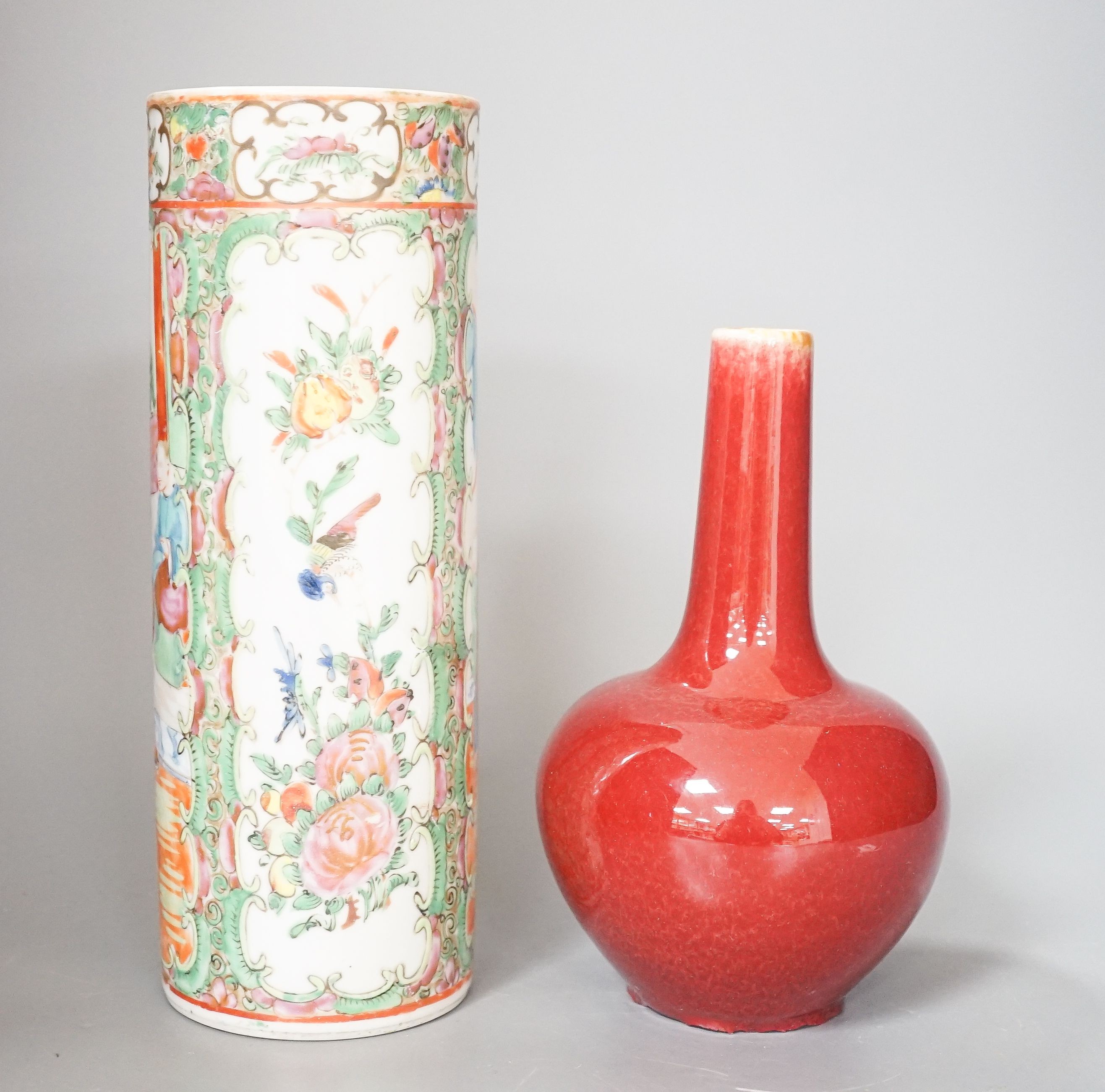 A Chinese famille rose cylindrical vase and a flambé bottle vase vase, tallest 24 cm